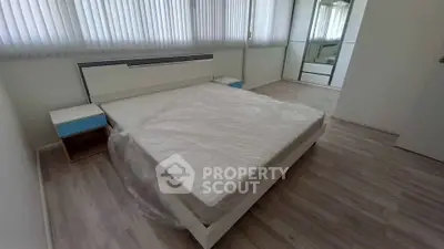 Spacious modern bedroom with sleek design and ample natural light