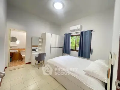Spacious bedroom with ensuite bathroom and modern furnishings