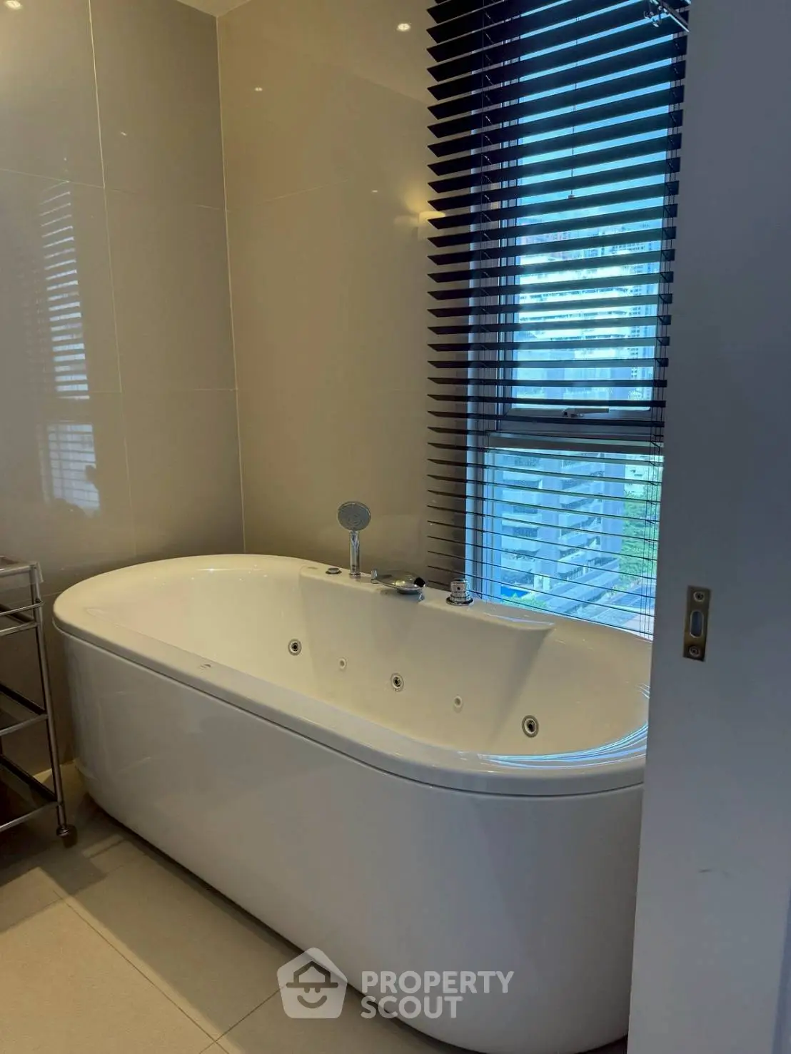 Luxurious bathroom with modern bathtub and city view window.