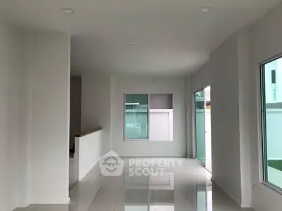 Spacious modern interior with large windows and glossy tile flooring.