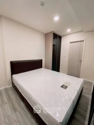 Modern bedroom with sleek design and new mattress in stylish apartment.