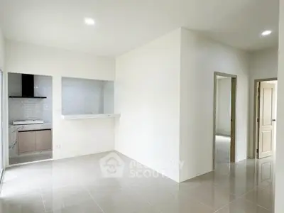 Spacious modern apartment interior with open layout and sleek kitchen design.