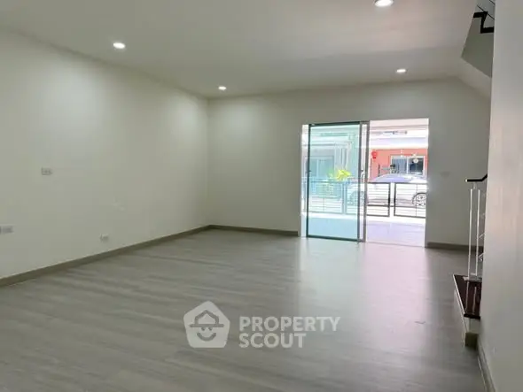 Spacious modern living room with large windows and sleek flooring
