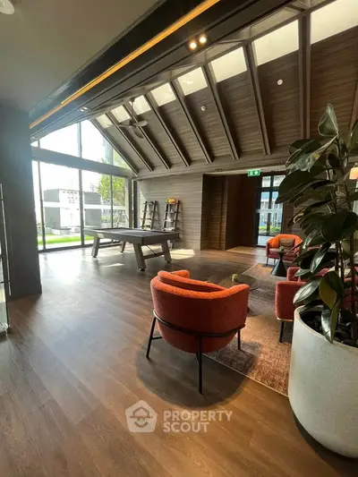 Luxurious modern living area with high ceilings and stylish furniture, perfect for relaxation and entertainment.
