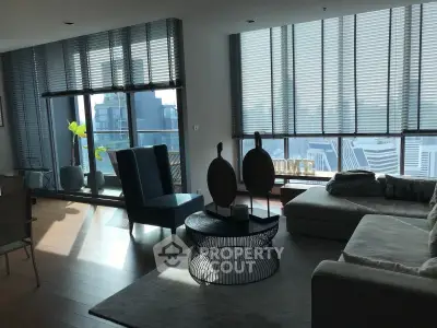 Spacious modern living room with large windows and city view