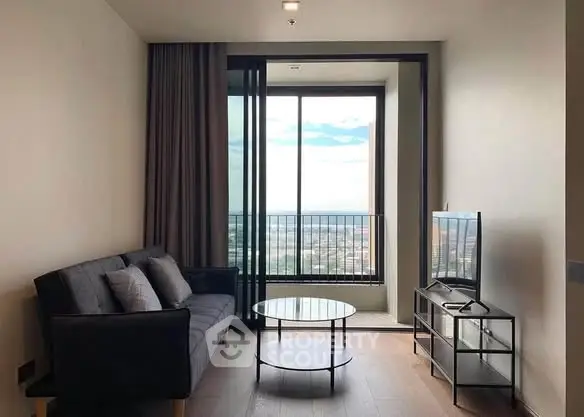 Modern living room with large window offering stunning city view, featuring sleek furniture and stylish decor.