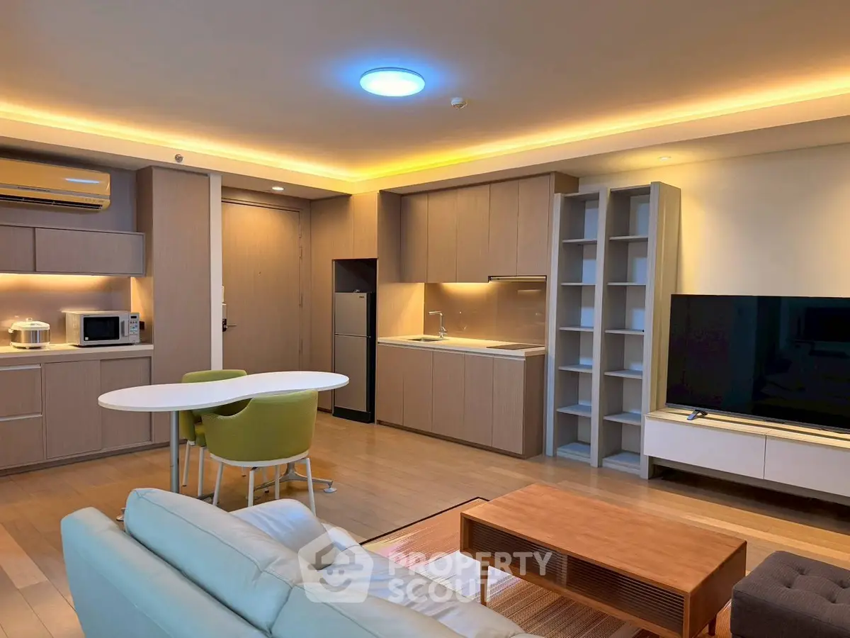 Modern open-layout living room with sleek kitchen and stylish furniture