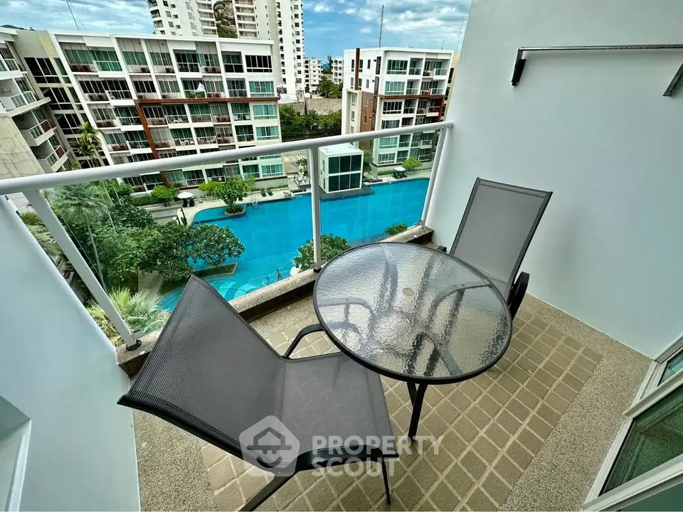 Charming balcony with pool view in modern apartment complex