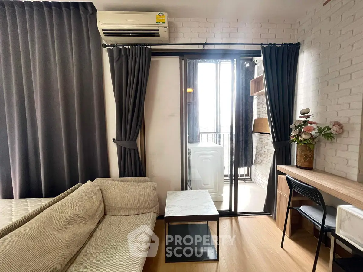 Modern living room with balcony and stylish decor in urban apartment.