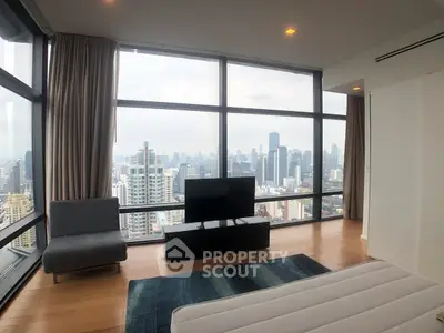 Luxurious high-rise apartment with panoramic city views and modern furnishings.