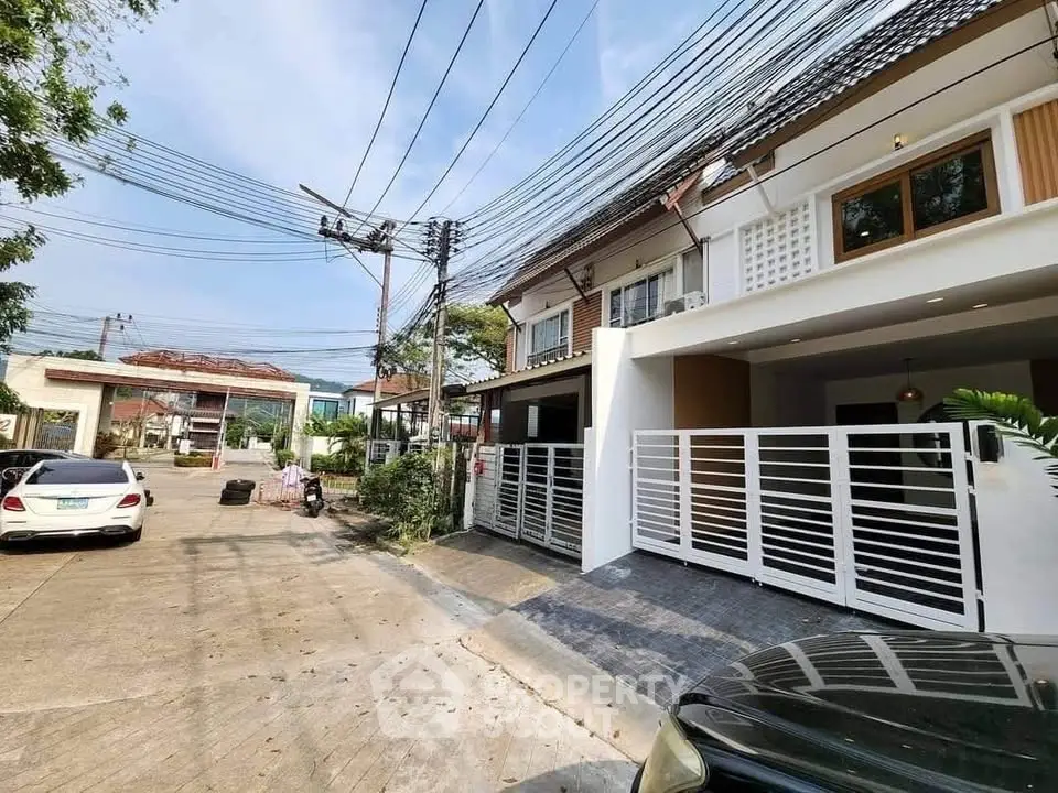 Charming townhouse with modern facade and gated entrance in a serene neighborhood.