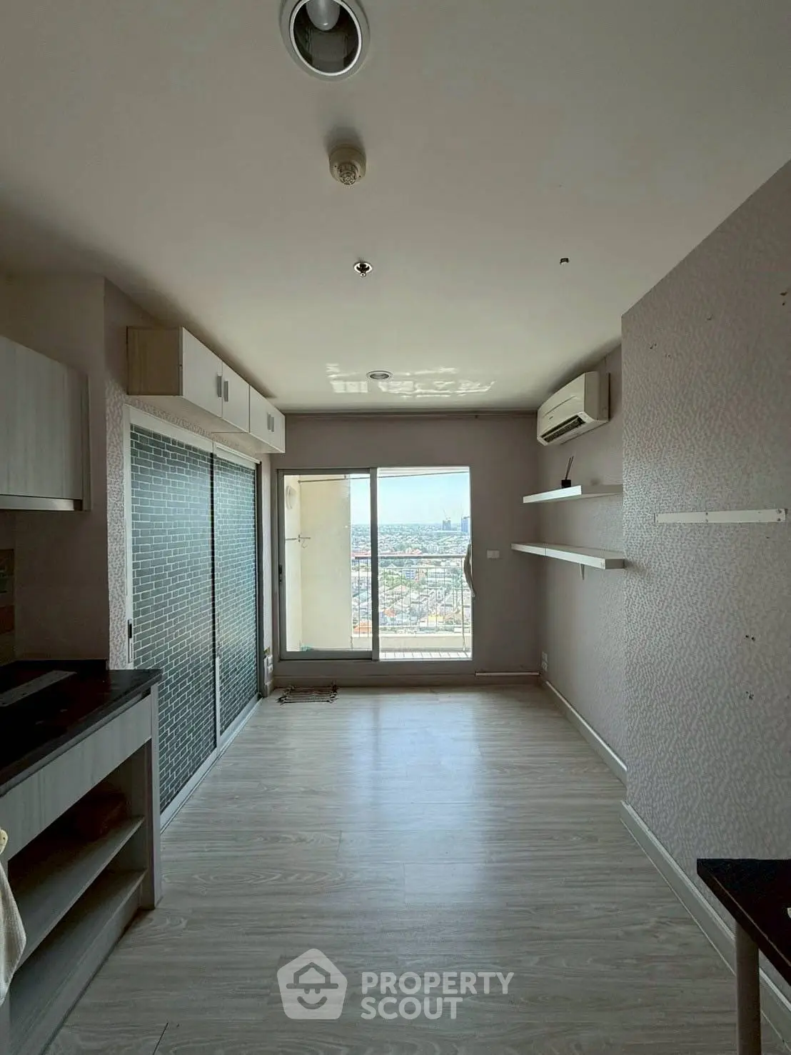 Spacious apartment with balcony offering stunning city views, modern interior design, and ample natural light.
