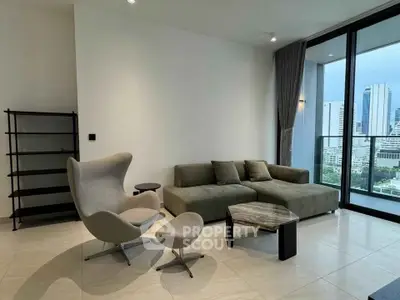 Modern living room with stylish furniture and city view from large windows.