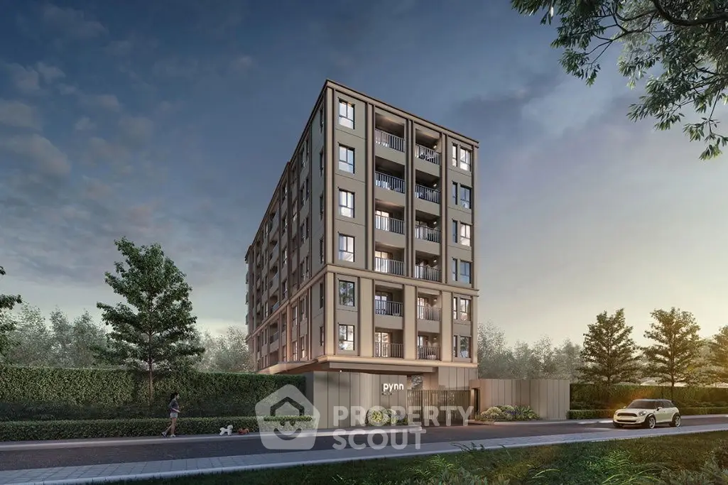 Modern apartment building with lush greenery and street view