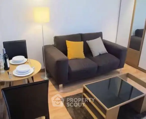 Cozy living room with modern furniture and dining area, perfect for urban living.
