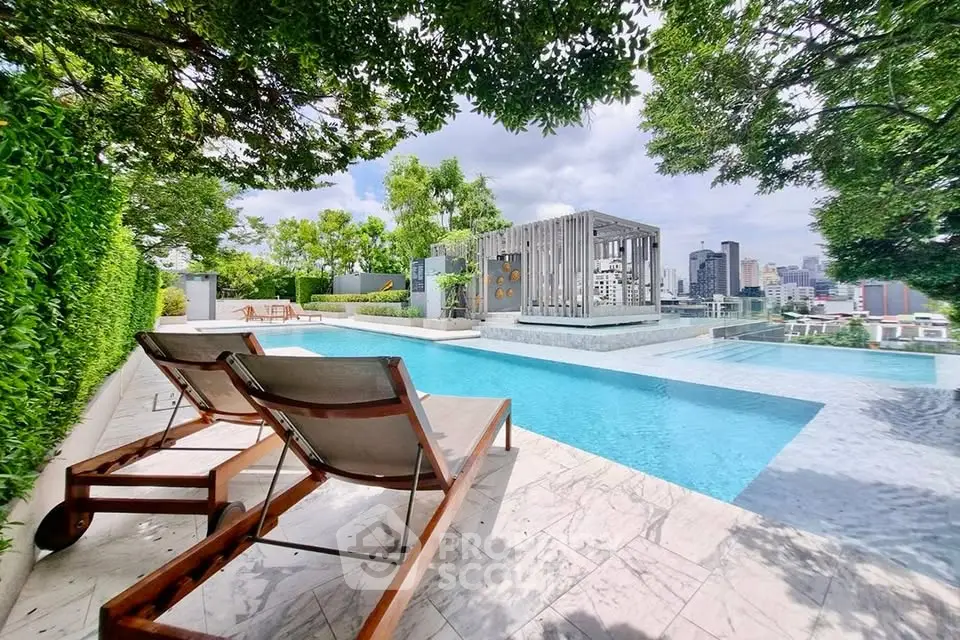 Luxurious rooftop pool with city skyline view and lush greenery, perfect for relaxation and leisure.