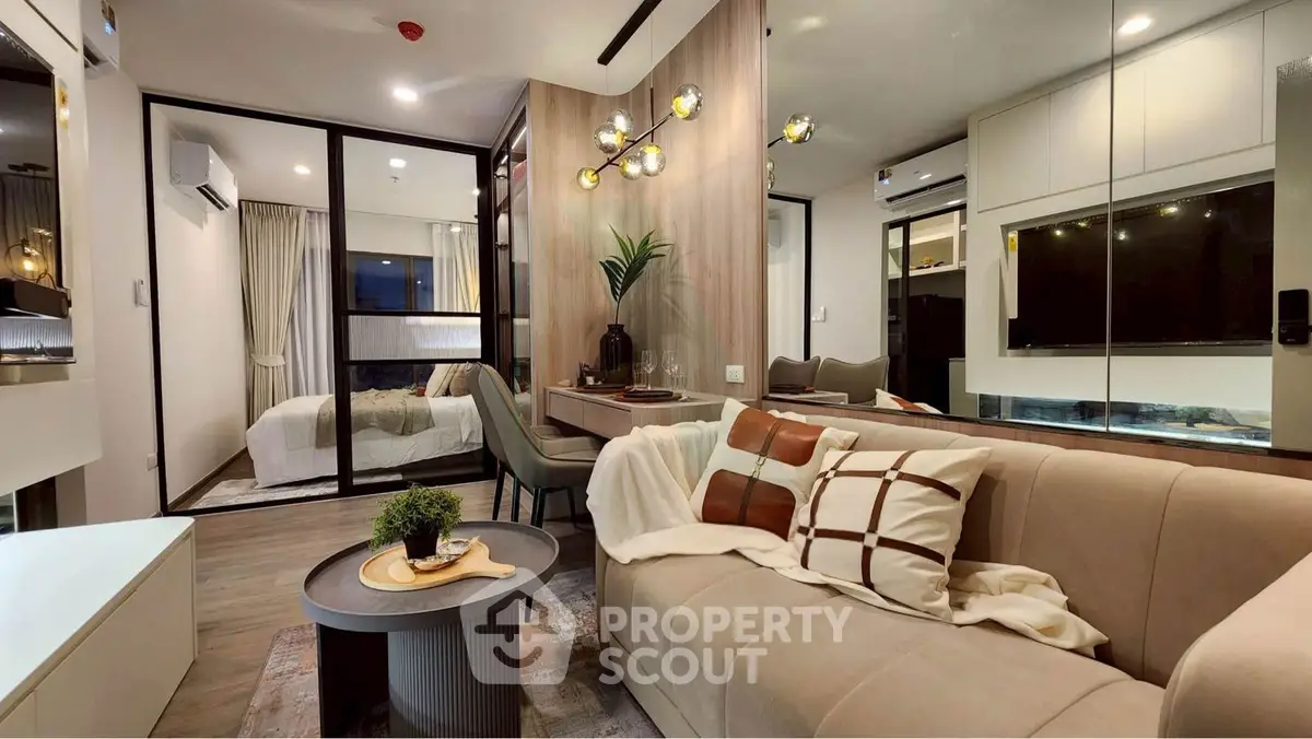 Modern living room with stylish decor and open view into cozy bedroom