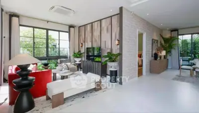 Spacious modern living room with stylish decor and large windows offering natural light.