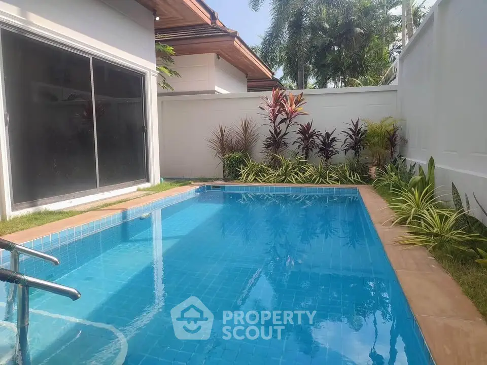 Charming private pool with lush garden in a serene residential setting, perfect for relaxation and leisure.