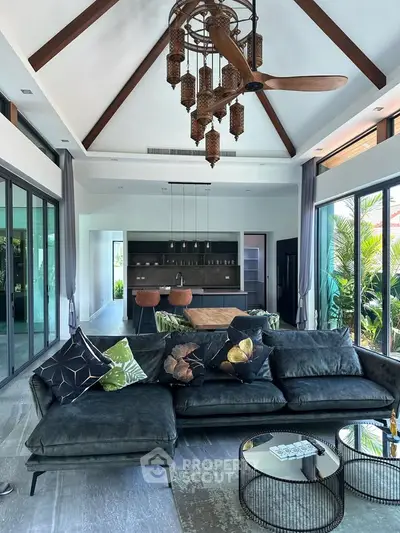 Luxurious modern living room with high ceilings, elegant decor, and large windows offering garden views.