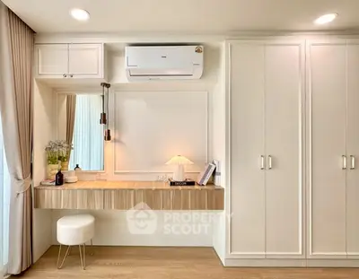 Modern bedroom with built-in wardrobe and stylish vanity area