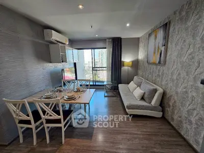 Modern living room with dining area and balcony view in stylish apartment.
