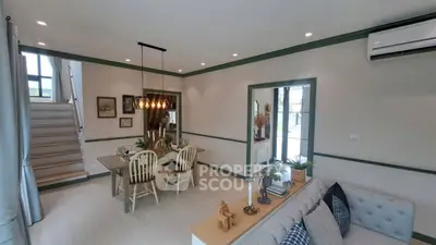 Charming living room with dining area, modern decor, and natural light.