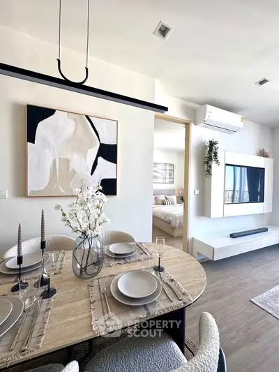 Modern dining area with elegant decor and view into cozy bedroom