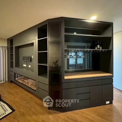 Modern interior with sleek black cabinetry and wooden flooring, perfect for stylish living spaces.