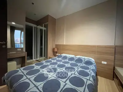 Cozy bedroom with modern decor and large window offering city views