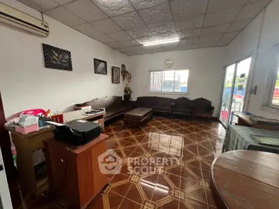Spacious living room with unique tile flooring and ample natural light