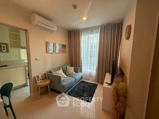 Cozy living room with modern decor and natural light, featuring a comfortable sofa and stylish furnishings.