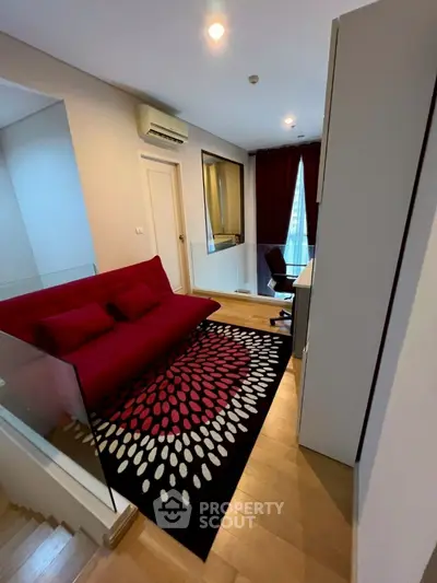 Stylish modern living room with red sofa and unique carpet design