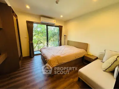 Cozy bedroom with balcony view and modern furnishings