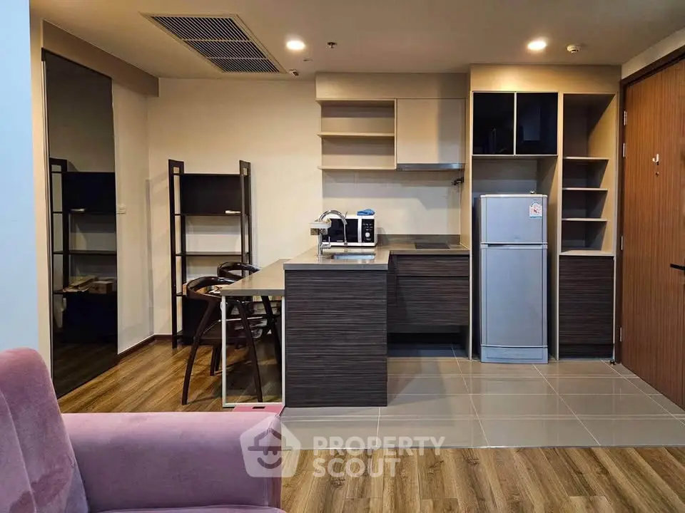 Modern kitchen with sleek cabinetry and stainless steel appliances in open layout