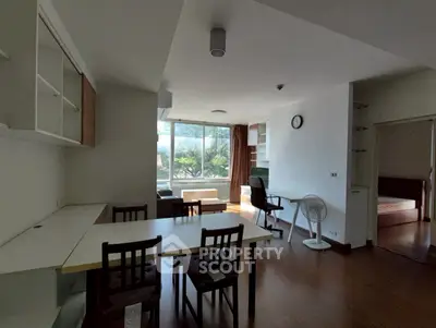 Spacious living room with modern furniture and large windows offering natural light.