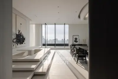 Luxurious modern living room with panoramic city views and elegant minimalist design.