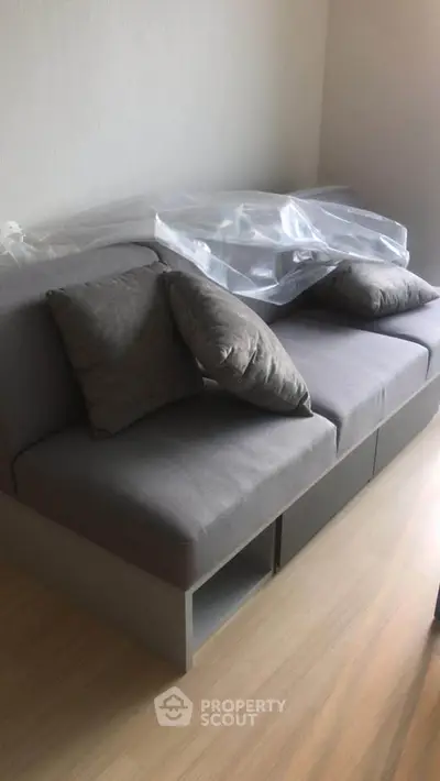Modern gray sofa with cushions in a stylish living room setting.