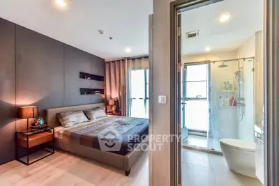Modern bedroom with ensuite bathroom featuring sleek design and cozy ambiance.