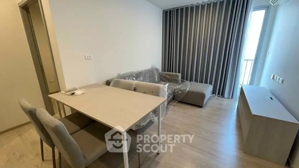 Modern living room with sleek furniture and natural light, perfect for urban living.