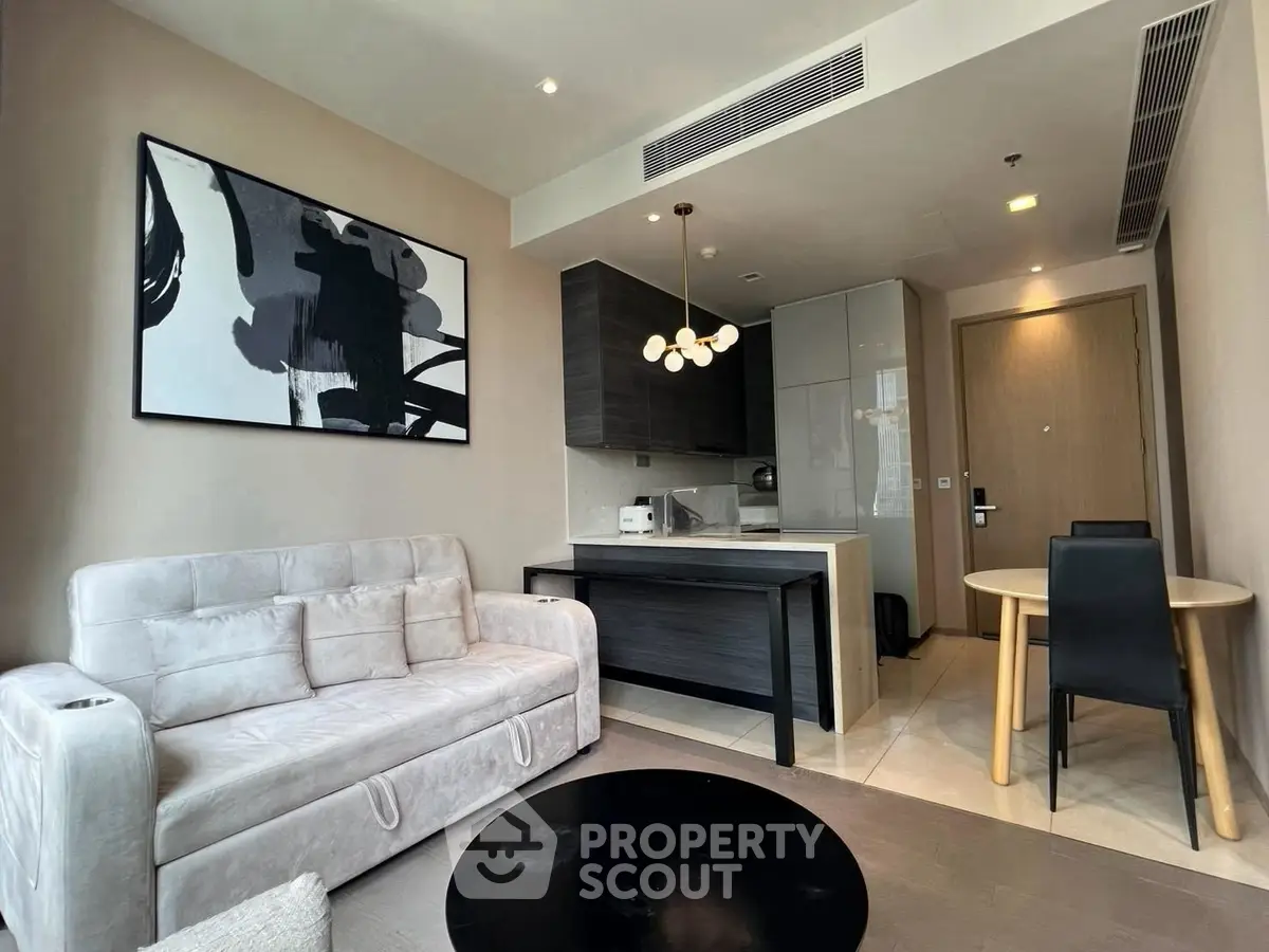 Modern living room with stylish decor and open kitchen layout in a contemporary apartment.