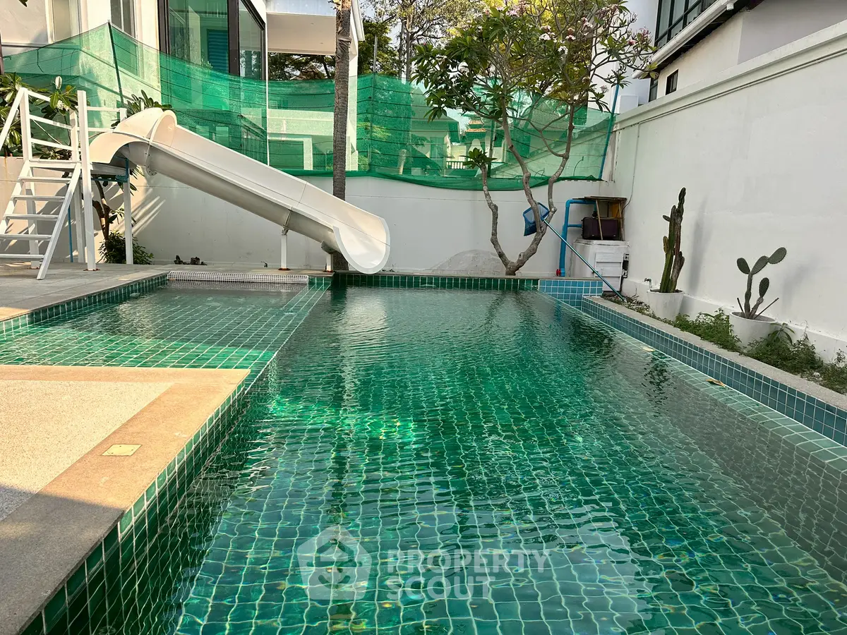 Luxurious private pool with slide in modern residential property