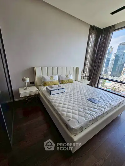 Luxurious bedroom with city view and elegant furnishings in modern apartment