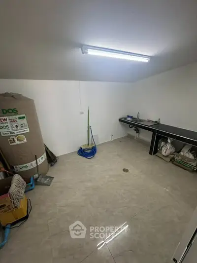 Spacious utility room with tiled flooring and ample storage space, perfect for organizing household essentials.