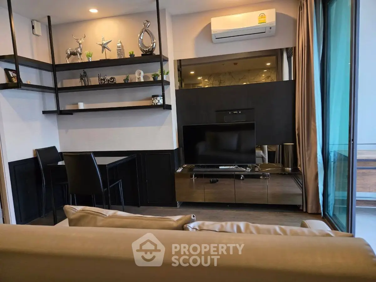 Modern living room with stylish decor and air conditioning, featuring a cozy seating area and entertainment setup.