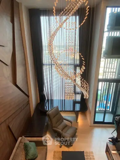 Luxurious living room with stunning chandelier and floor-to-ceiling windows