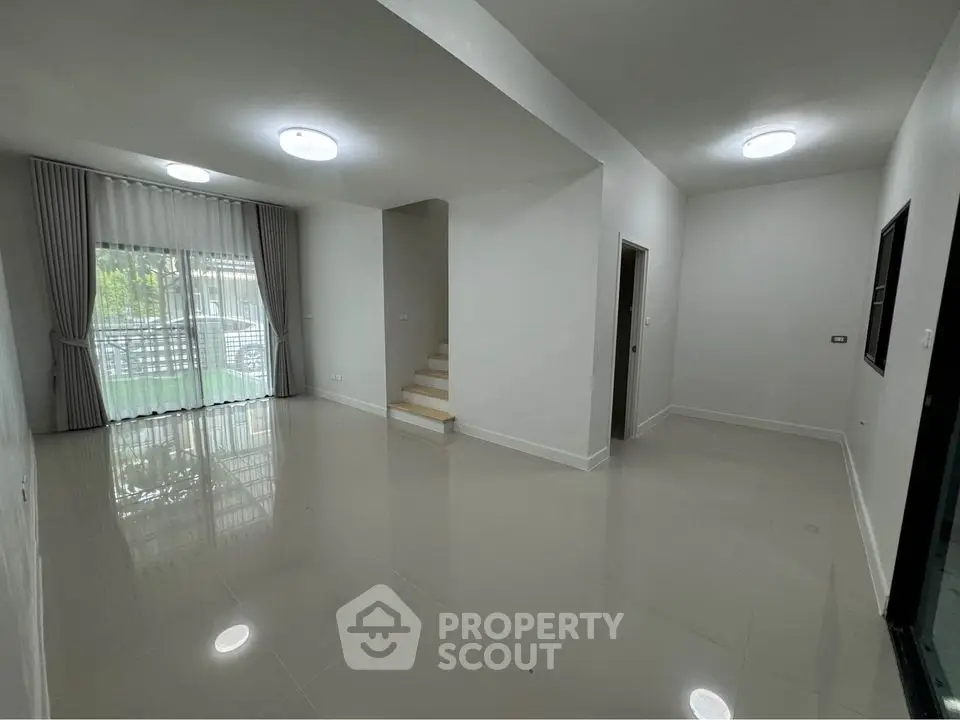 Spacious modern living room with glossy floors and large windows