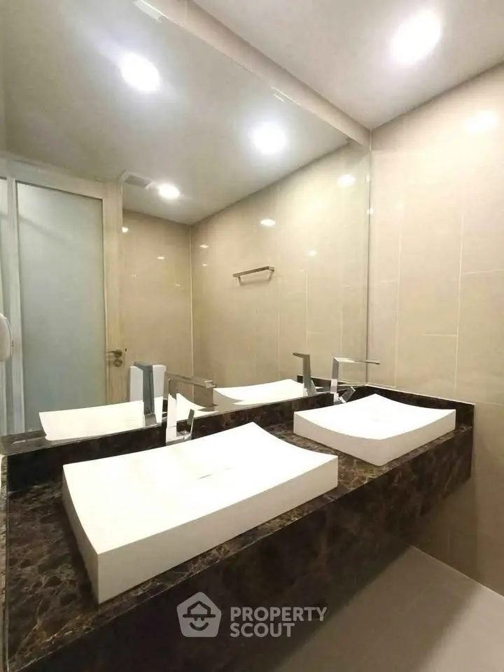 Modern bathroom with dual sinks and elegant marble countertop