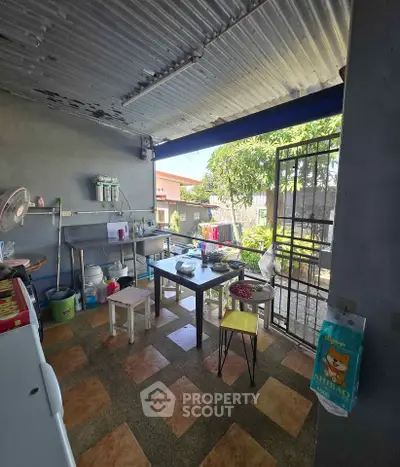 Charming outdoor kitchen with rustic decor and garden view, perfect for al fresco dining.