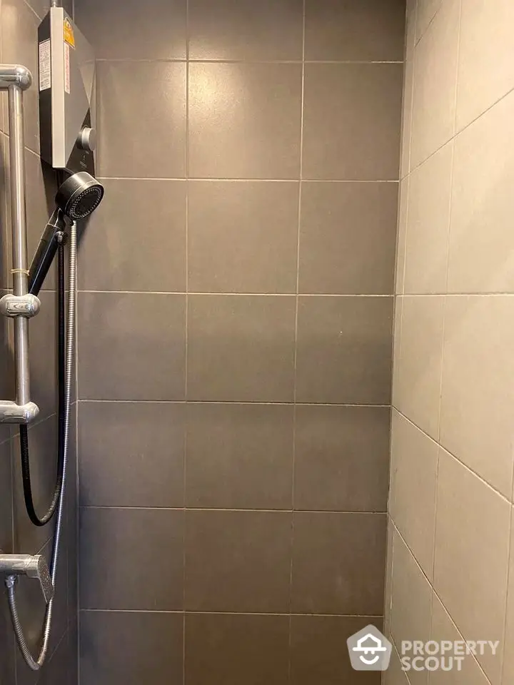 Modern bathroom shower with sleek tiles and contemporary fixtures